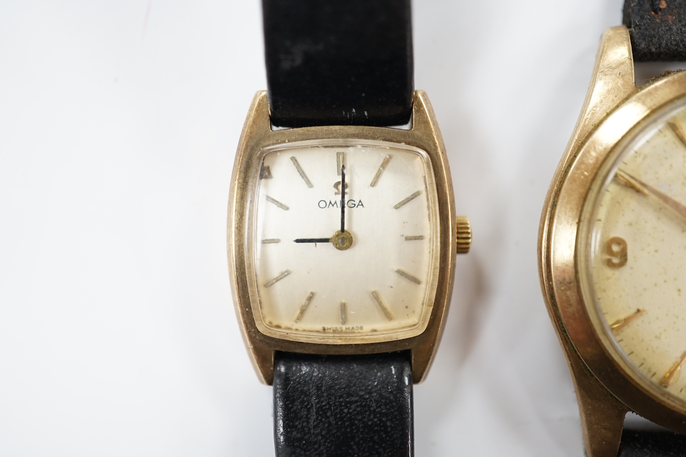 A gentleman's 9ct gold Omega manual wind wrist watch, on associated strap and a lady's 9ct gold Omega manual wind wrist watch.